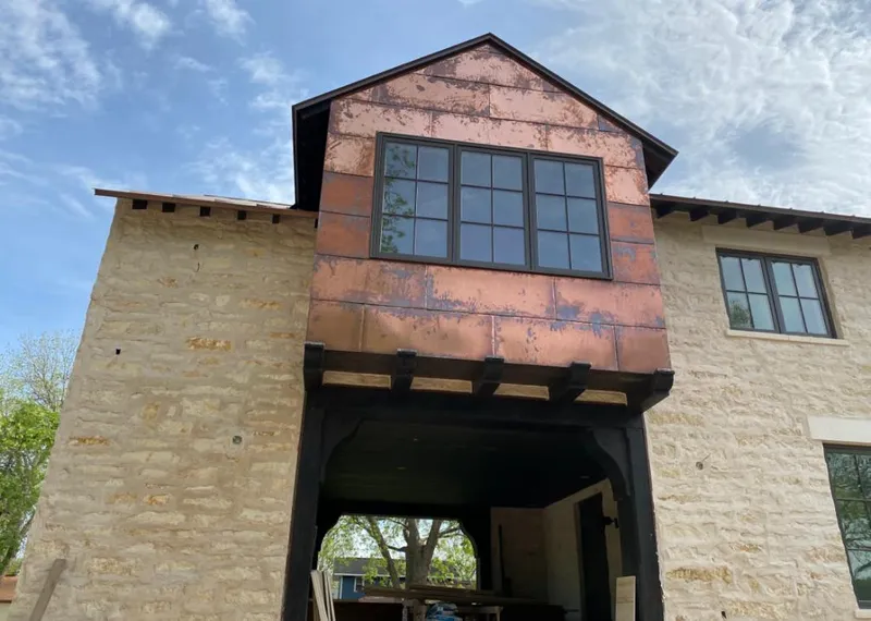 Copper metal panel facade on a stone building for Skylight Installation in Orchards